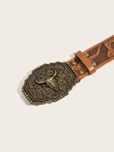 Close-up detail of western cowboy style brown leather belt with vintage bull skull metal buckle.