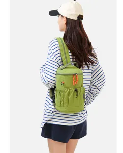 Green multi-functional mini outdoor backpack detail view, featuring vibrant orange zipper pulls.