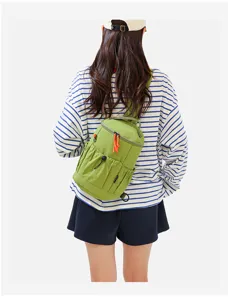 Detail view of the multi-functional green outdoor casual crossbody backpack with orange pull cords.
