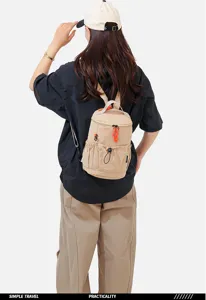 Multi-functional small outdoor backpack, casual travel sling bag in khaki with orange details.