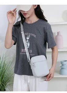 Detailansicht der minimalistischen hellgrauen Umhängetasche am Model für den Alltag.