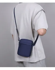 Detailansicht der lässigen, marineblauen Oxford-Stoff Umhängetasche für das Handy am Model.
