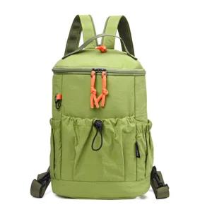 Green casual outdoor mini backpack with orange zipper pulls and side pockets for daily travel.
