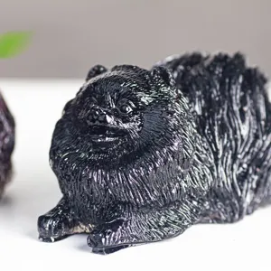 Close-up detail of a glossy black Pomeranian dog figurine sculpture, smooth surface.
