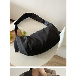 Schwarze Daunen-Crossover-Tasche, minimalistische weiche Schultertasche Detailansicht.