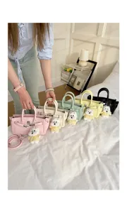 Detailed view of stylish Litchi pattern women handbag with cute puppy pendant, perfect for daily commuting.
