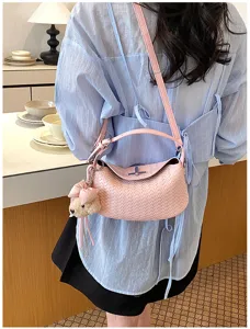 Stylish pink woven leather shoulder bag with chic charm for women commuting and daily wear.