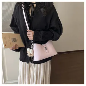 Detailed view of the stylish pink shoulder underarm bag featuring a metallic lock and charm.