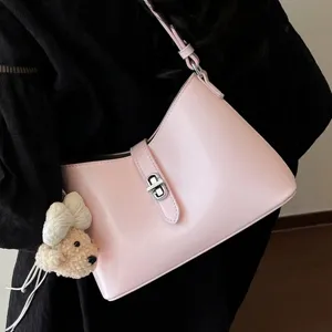 Minimalist pink underarm shoulder bag for women, trendy chic handbag with metal lock and cute bear.