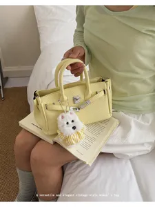 Korean style litchi pattern handbag detail, featuring classic design, metal lock and cute pendant.