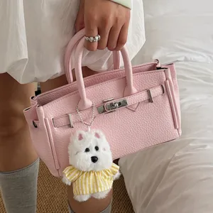 Pink litchi pattern women's handbag, stylish Kelly style bag for daily commute and versatile use.