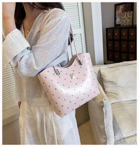 Pink polka dot shoulder tote bag detail shot showing stylish design, soft leather and daily use.
