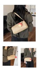 Stijlvolle casual cilindrische schoudertas voor dames, trendy okseltas met schattige appelhangers.