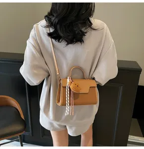 Stylish minimalist Korean style handbag for women, versatile crossbody shoulder bag with cute charm.