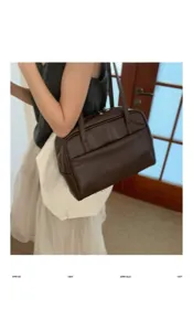 Detail shot of a minimalist dark brown leather shoulder bag in a daily indoor lifestyle scene.