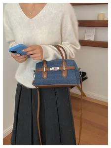 Chic denim Boston handbag with brown leather trim, casual stylish pillow shoulder cross body bag.