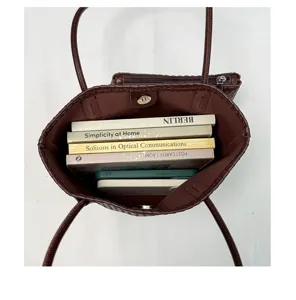 Detailed top view of brown woven leather tote bag, stylish retro large capacity interior showcase.