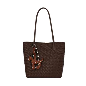 Brown woven tote bag for women, stylish leather shoulder bag with cute dog charm and top handles.