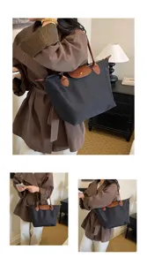 Versatile large capacity nylon tote bag with brown leather handles and classic flap design.