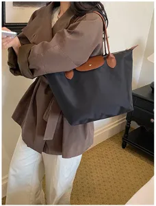 Classic black nylon tote bag with brown leather flap and handles, large capacity travel handbag.