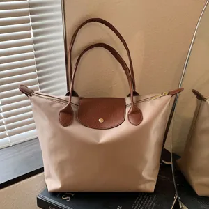Waterproof nylon tote bag with top handle, large capacity casual travel shoulder dumpling bag.