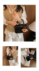 Retro black handbag detail, cute bear pendant, stylish commuter shoulder bag for women.
