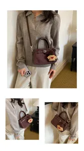 Retro brown suede shoulder bag with cute bear pendant, stylish women daily commute handbag.