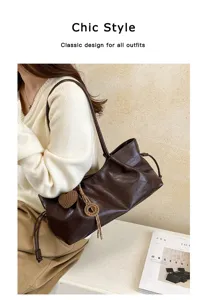 Detailed view of the retro soft leather brown shoulder bag with chic gathered design and strap.
