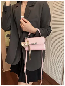 Chic pink retro top handle crossbody bag with heart pendant, stylish daily commute small square bag.