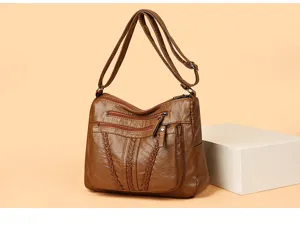 Stylish large capacity brown leather shoulder bag crossbody bag with multiple zipper pockets.