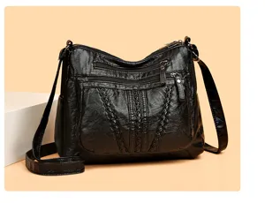 Details of black PU leather shoulder bag featuring multi-zipper pockets and braided texture.