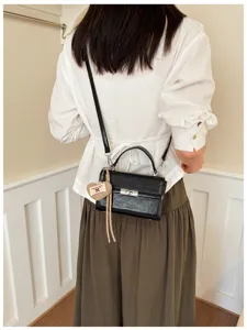 Stylish black retro handbag for women, chic PU leather crossbody bag with top handle.