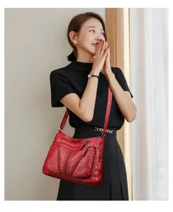 Red multi-pocket soft leather shoulder bag for women, stylish large capacity crossbody tote.