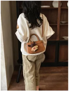 Vintage women handbag retro shoulder crossbody bag with cute bear pendant for daily commute.