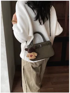 Retro brushed shoulder crossbody bag for women, stylish commuting handbag with cute bear pendant.