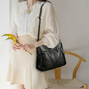 Black leather shoulder bag for women, large capacity multi-pocket tote bag with strap.