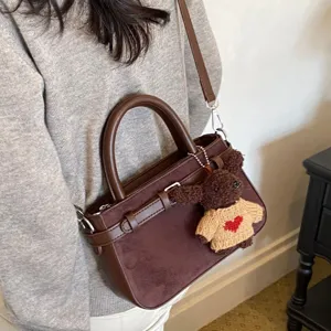 Retro brown suede top-handle crossbody bag, stylish women commuting shoulder bag with cute bear.