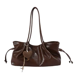 Retro large capacity shoulder bag for women, stylish versatile commuter tote handbag with heart pendant.