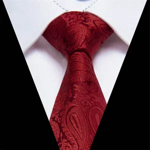 Red paisley necktie detail shot, elegant jacquard pattern fabric texture for men's formal suit.