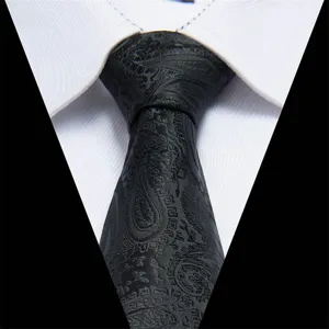Classic black paisley silk tie detail for men, elegant wedding business suit accessory.