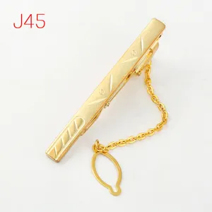 Detailed shot of a gold-toned men's tie clip featuring a geometric jacquard design and chain.