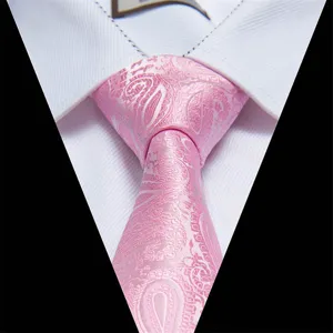 Detail view of a classic men's pink paisley jacquard silk tie paired with a crisp white shirt.