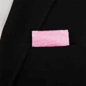 Close-up view of a pink paisley pocket square neatly folded inside a black suit pocket.