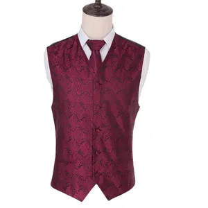 Close-up detail of the luxurious burgundy paisley jacquard fabric and stylish men waistcoat.