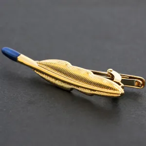 Golden feather metal tie clip for men, elegant business suit accessory with blue tip accent.