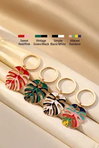 Colorful enamel monstera leaf keychain metal keyring bohemian beach bag pendant charm accessory.