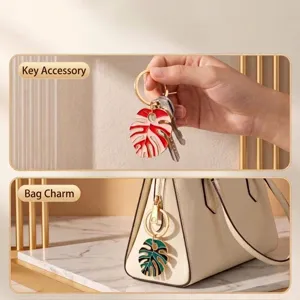Enamel monstera leaf keychain bag charm for women, stylish boho botanical accessory.