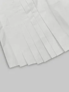 Close-up detail of the elegant white pleated fabric showing fine stitching and texture.