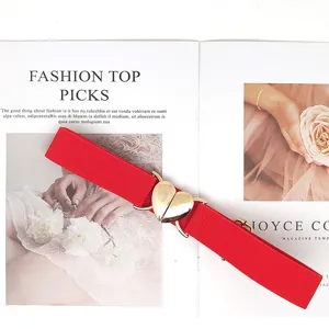 Women red elastic waist belt with cute gold heart metal buckle for stylish outfits.