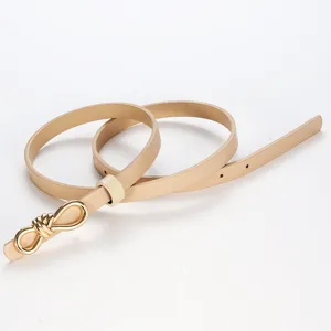 Elegant women's thin leather belt with a chic gold metal knot buckle for dresses and jeans.